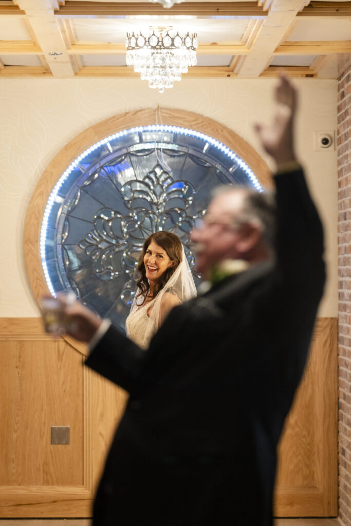 a man and a woman standing in front of a window