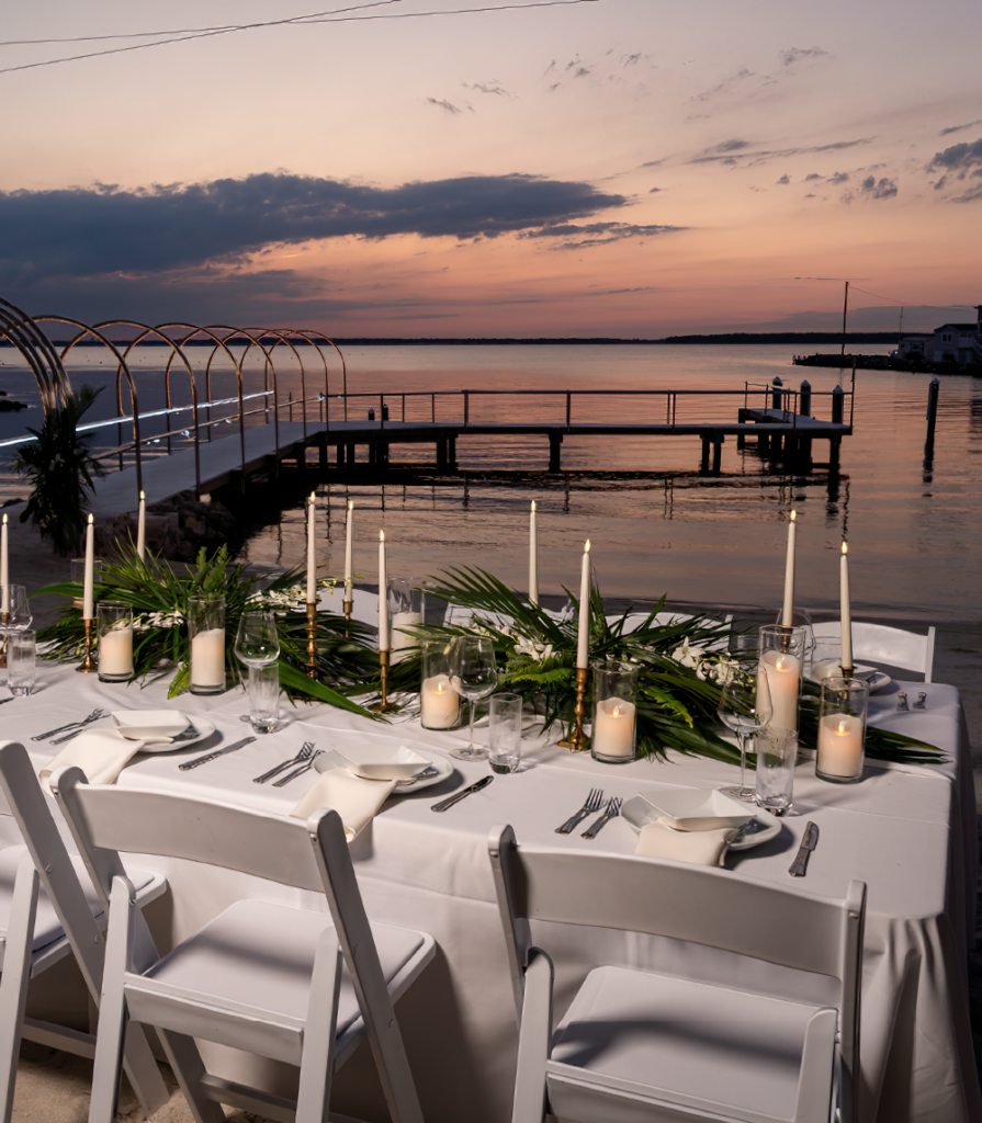 a table set up for a dinner with candles and flowers