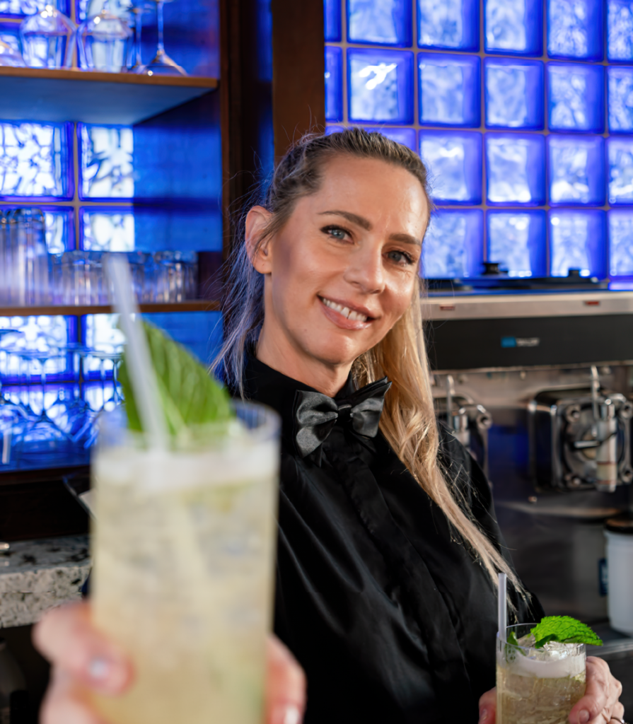 a woman holding a drink in a bar