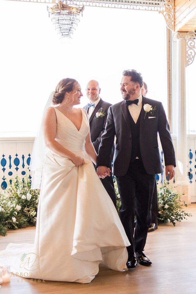 a bride and groom walking down the aisle