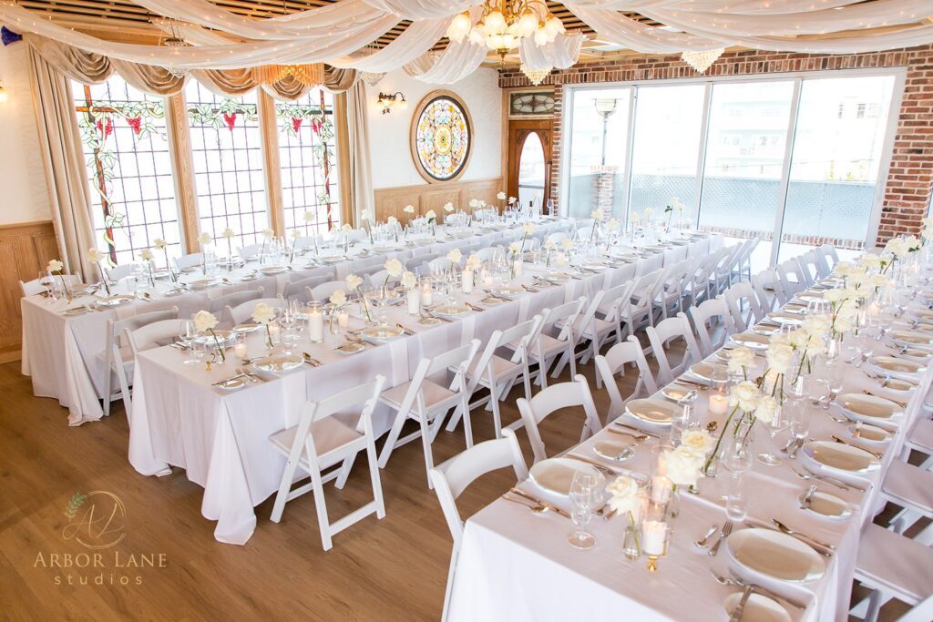 a room filled with lots of tables covered in white cloths