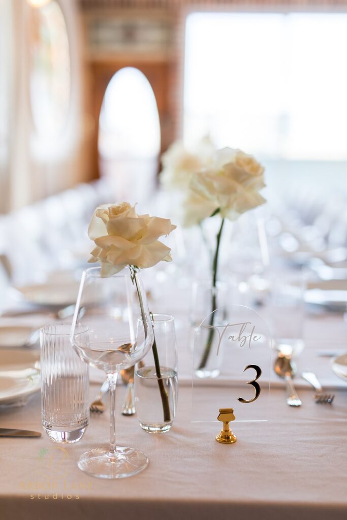 a table set for a wedding reception with flowers in vases