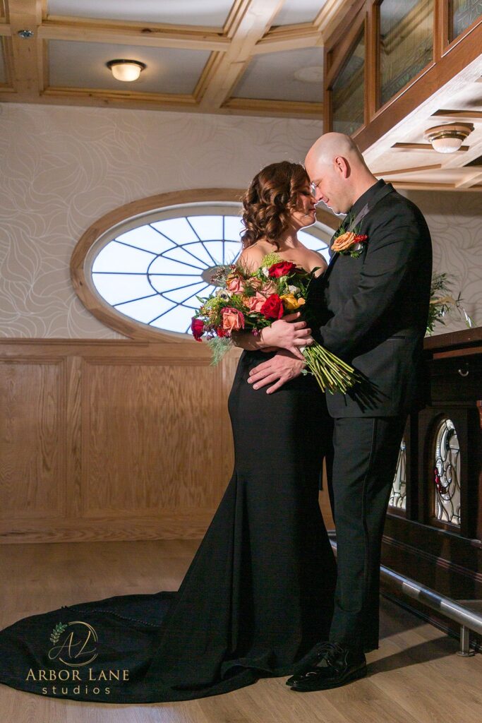 a bride and groom standing in front of a piano