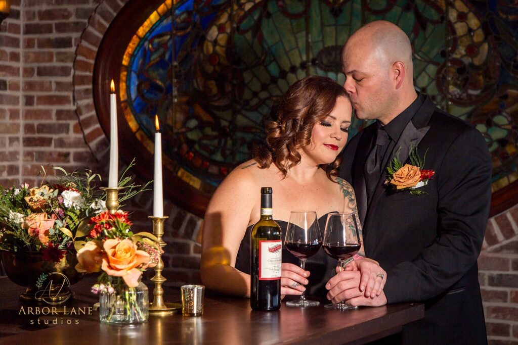 a man and a woman standing next to each other holding wine glasses