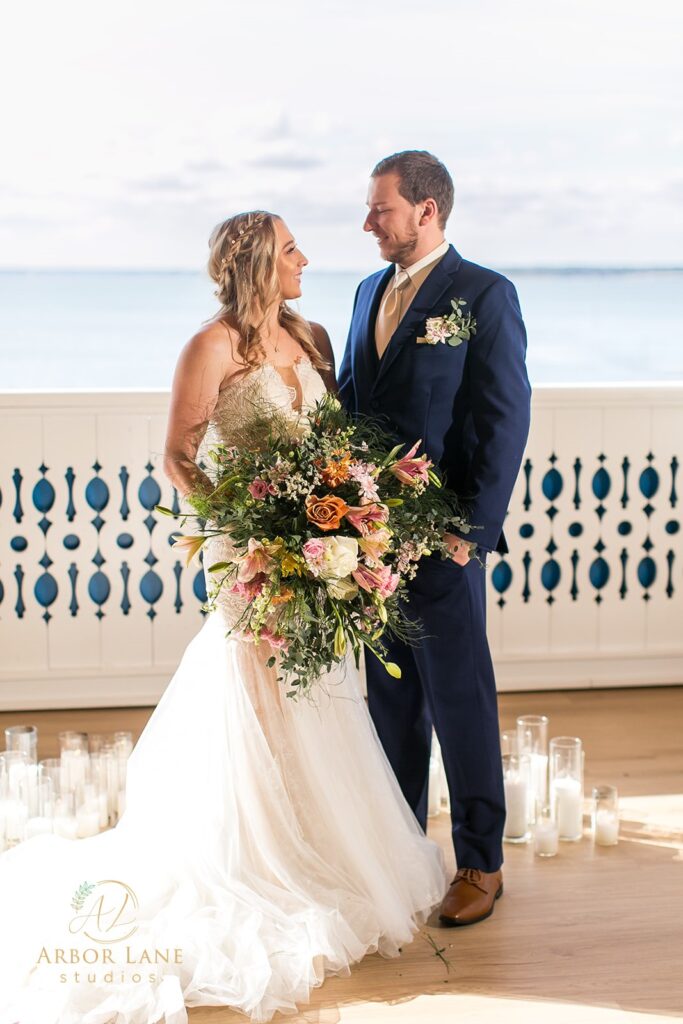 a bride and groom smile at each other