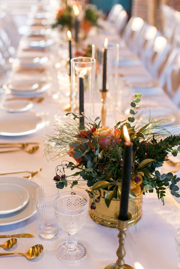 a long table with white table cloths and place settings