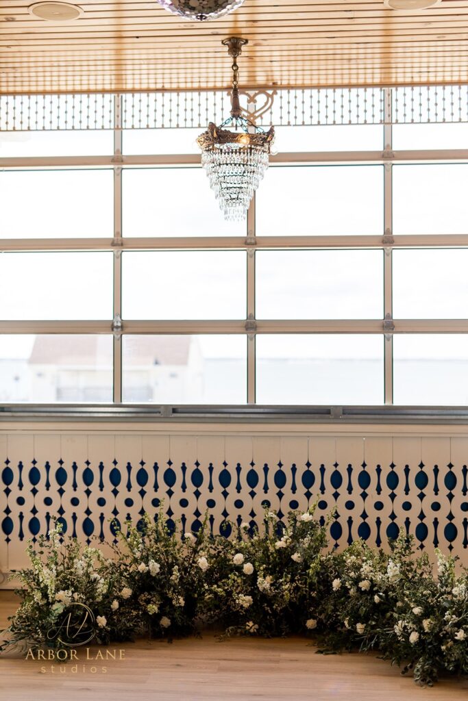 a bride and groom standing in front of a window