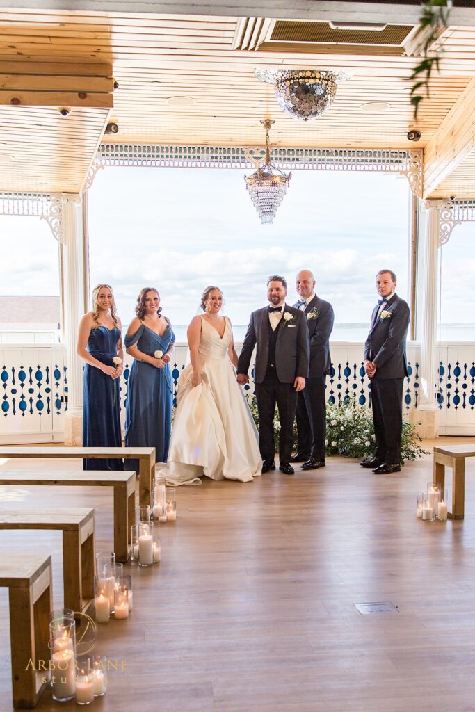 a bride and groom standing in front of their wedding party