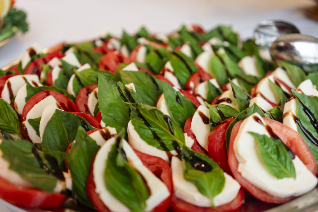 a platter of tomatoes and mozzarella on a table