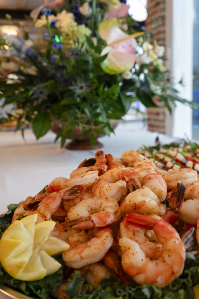 a plate of food with shrimp and lemon wedges