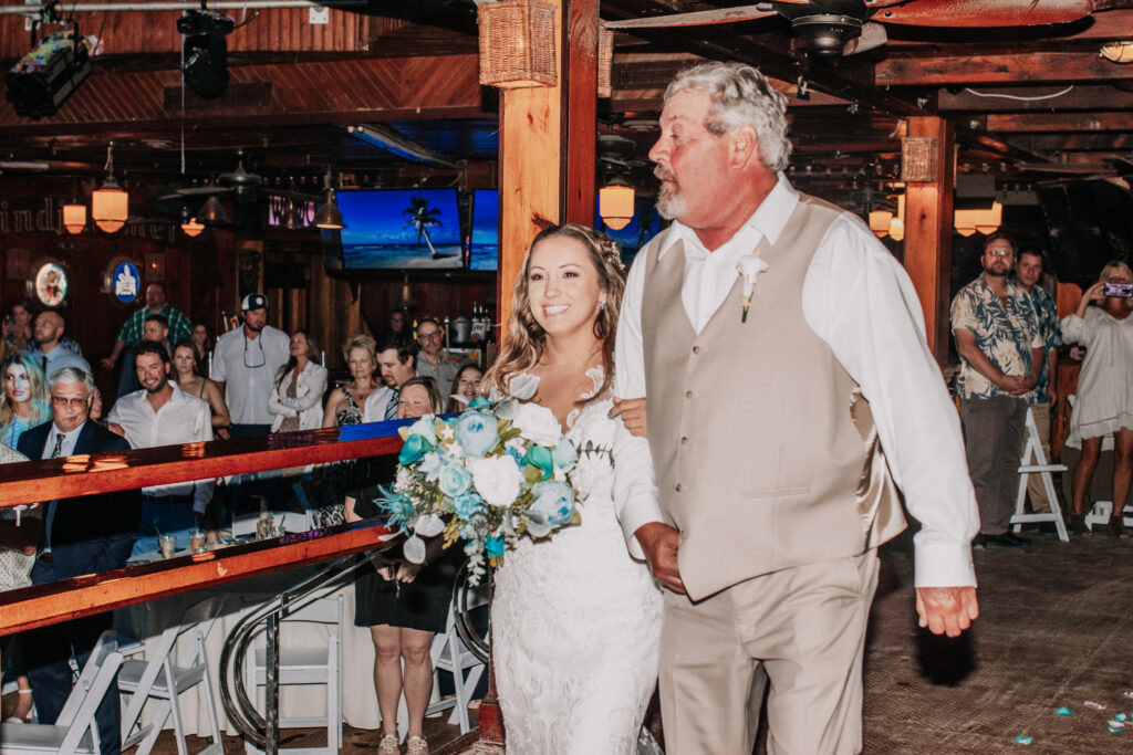 a bride and her father walking down the aisle