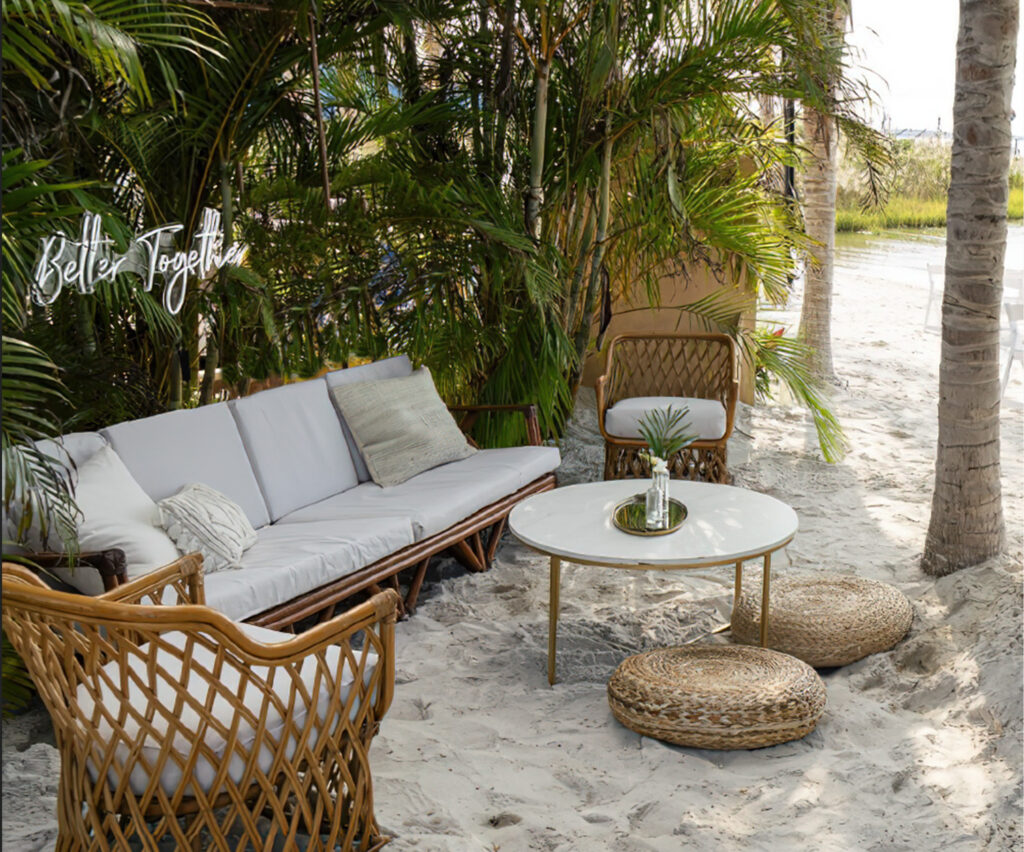 a living room filled with furniture and palm trees