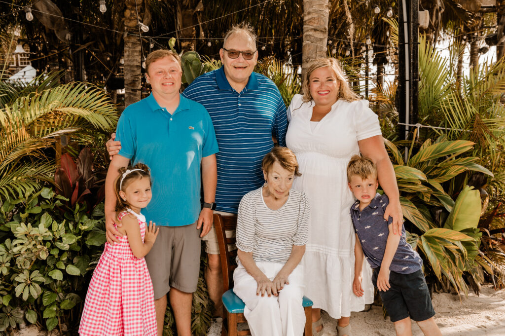 a family posing for a picture on the beach