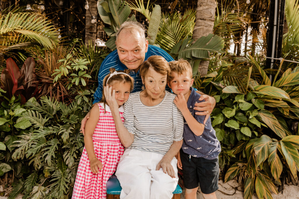 a man sitting on a bench with two children