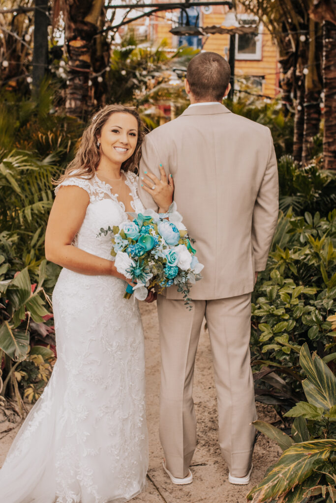 a bride and groom walking down a path