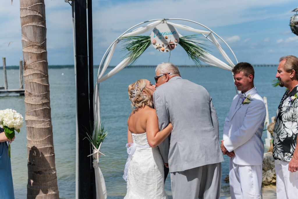 a couple getting married at the end of their wedding ceremony