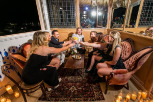 a group of people sitting around a wooden table