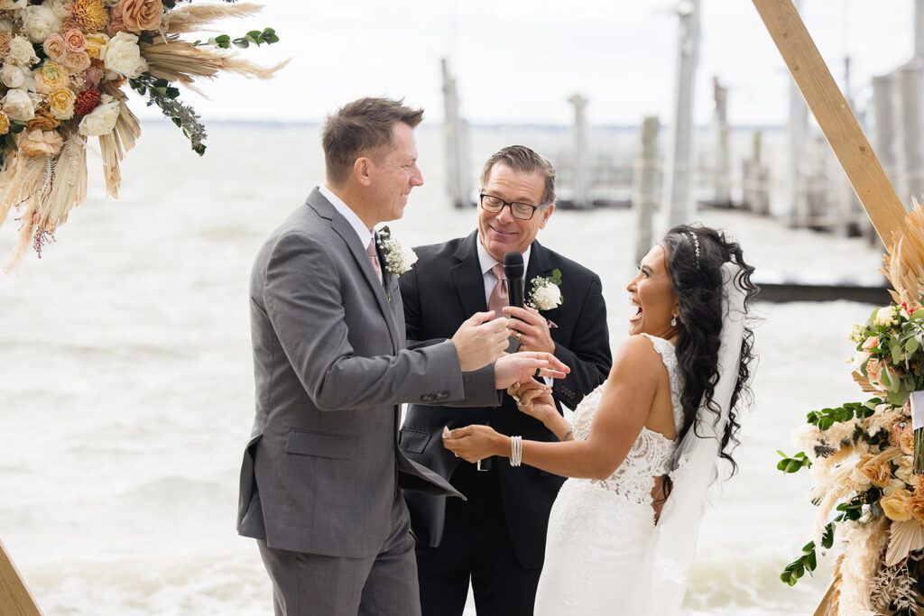 a man and a woman standing under a wedding arch