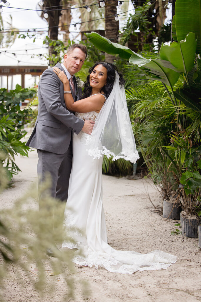 a bride and groom pose for a wedding photo