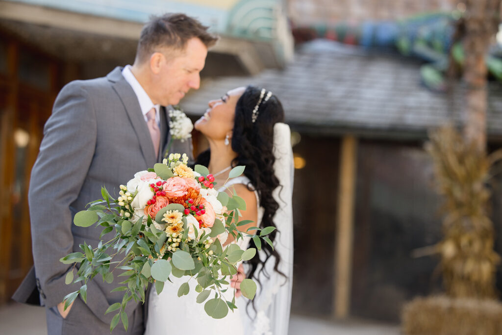 a bride and groom smile at each other