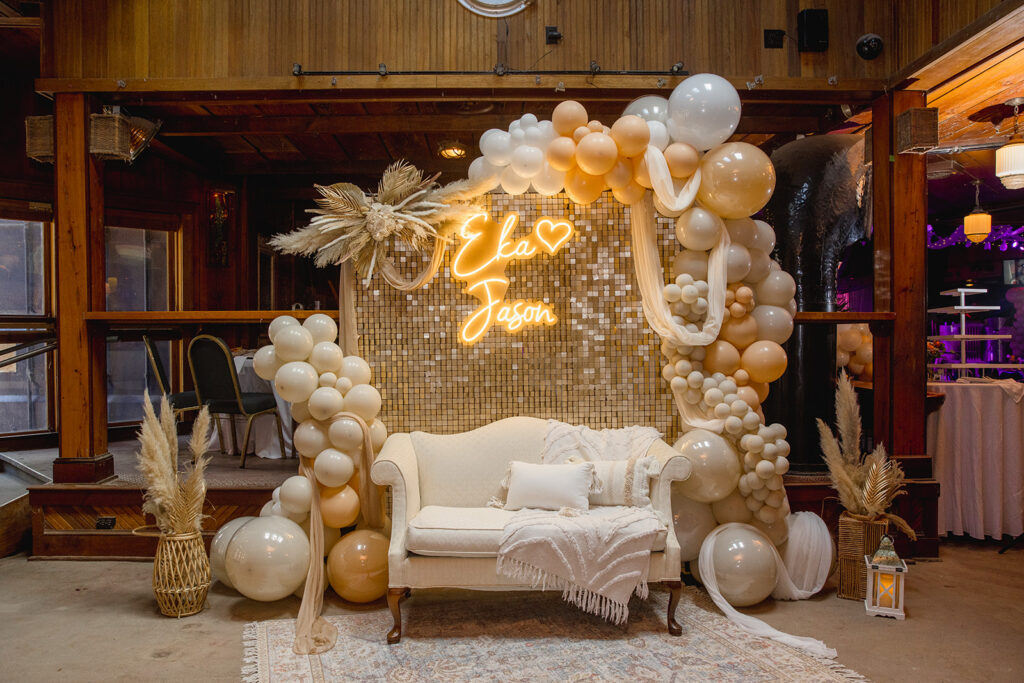 a room decorated with balloons and a couch